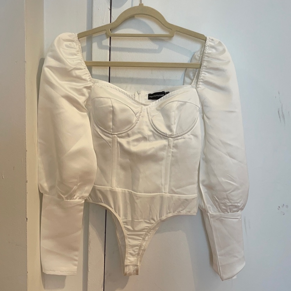 Body suit with corset-style top and puffed sleeves from PLT. Never been worn.
